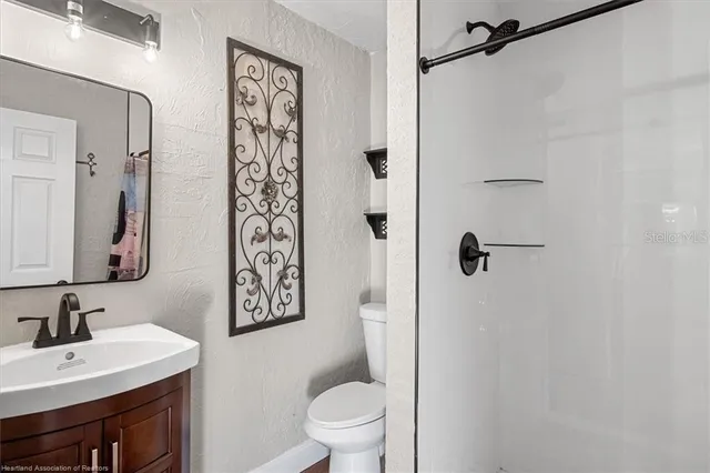 a bathroom with a toilet sink and shower