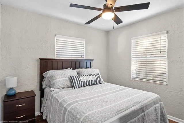 a bedroom with a bed and a tv