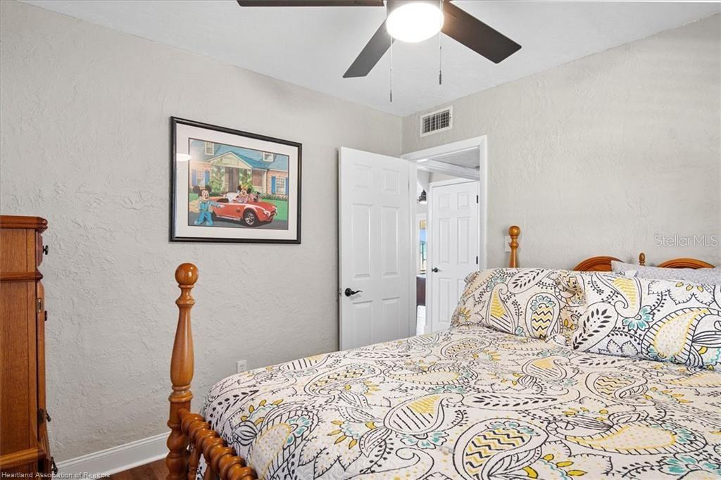 564 Lake June Road Lake Placid, FL 33852 - Photo 19 of 49 a bedroom with bed and wooden floor