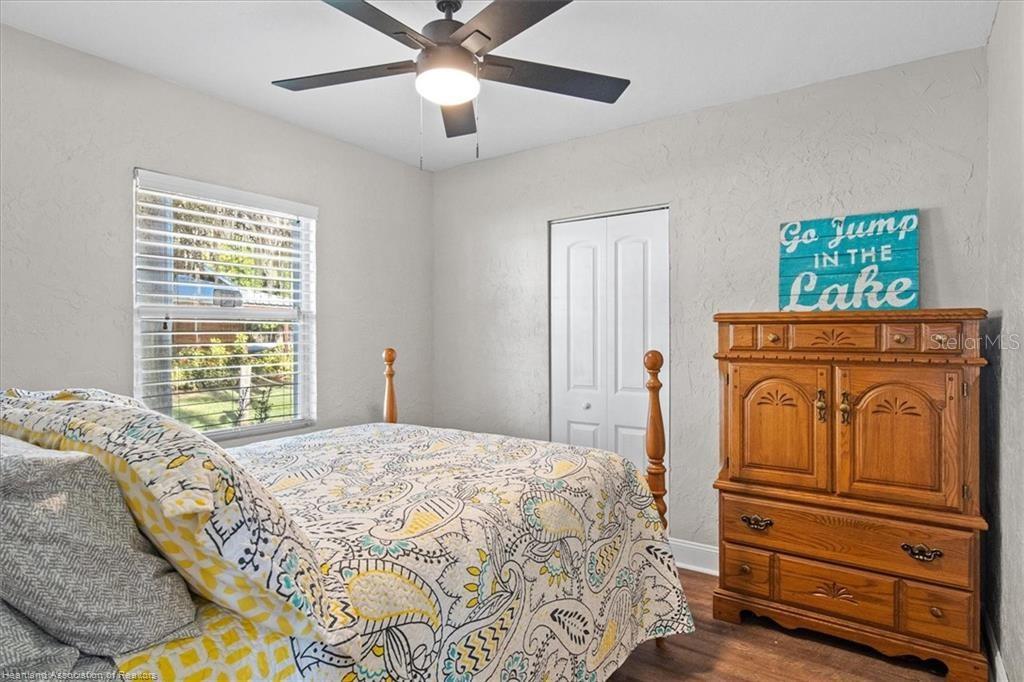 564 Lake June Road Lake Placid, FL 33852 - Photo 20 of 49 a bedroom with a bed and wooden floor