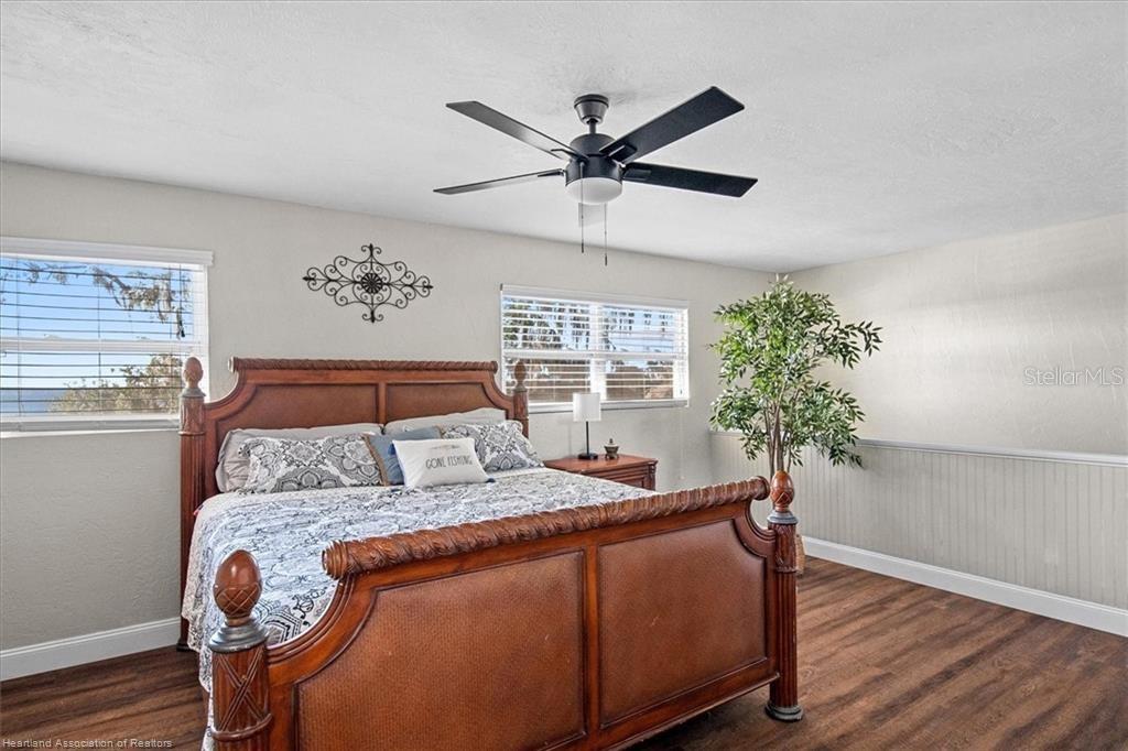 564 Lake June Road Lake Placid, FL 33852 - Photo 29 of 49 a bed sitting in a bedroom next to a window with a potted plant