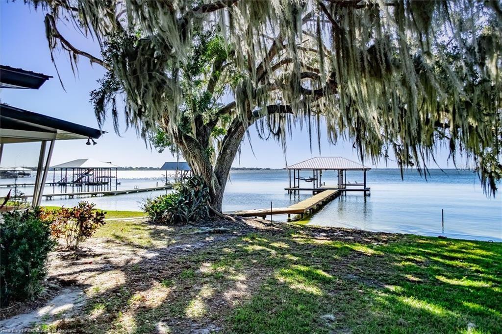 564 Lake June Road Lake Placid, FL 33852 - Photo 9 of 49 a view of a swimming pool with a bench and trees around