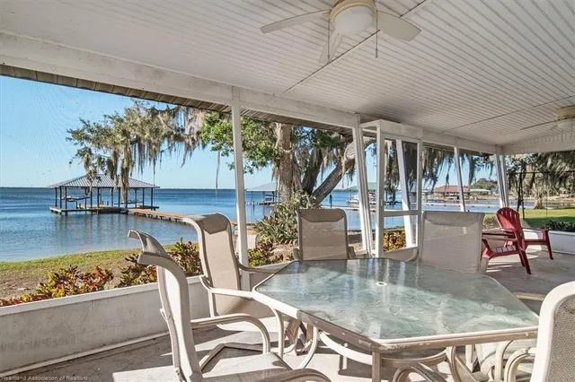 a dining room with furniture and a floor to ceiling window