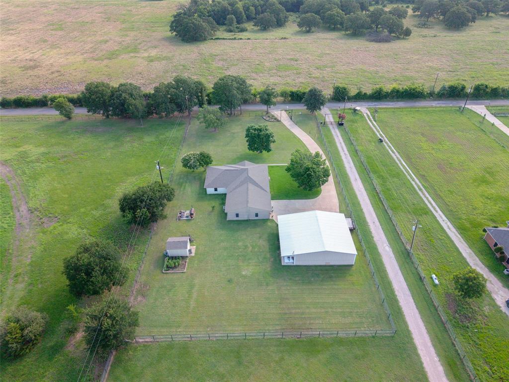 380 Farr Altom Road Seagoville, TX 75159 - Photo 29 of 30 Expansive property featuring a single-story residence, a large detached outbuilding, a fenced perimeter, and a long gravel driveway