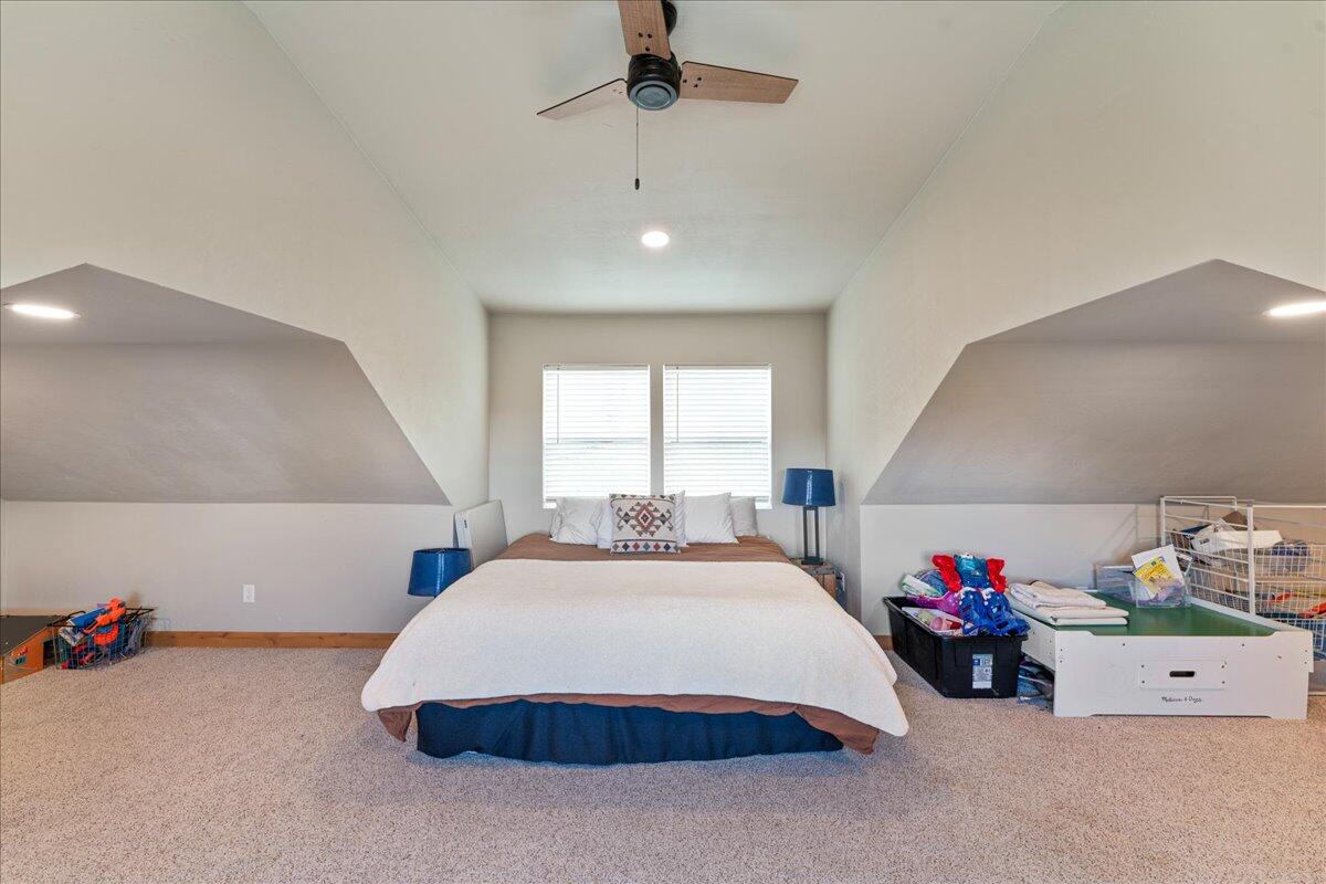 2220 Butte Falls Highway Eagle Point, OR 97524 - Photo 46 of 69 a spacious bedroom with a bed and a chandelier