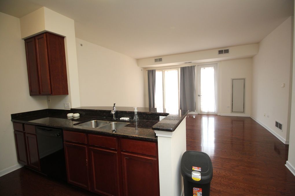 50 South Grove Avenue, Unit 410 Elgin, IL 60120 - Photo 3 of 12 a kitchen with granite countertop a sink and cabinets