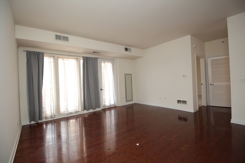 50 South Grove Avenue, Unit 410 Elgin, IL 60120 - Photo 5 of 12 a view of an empty room with wooden floor and a window