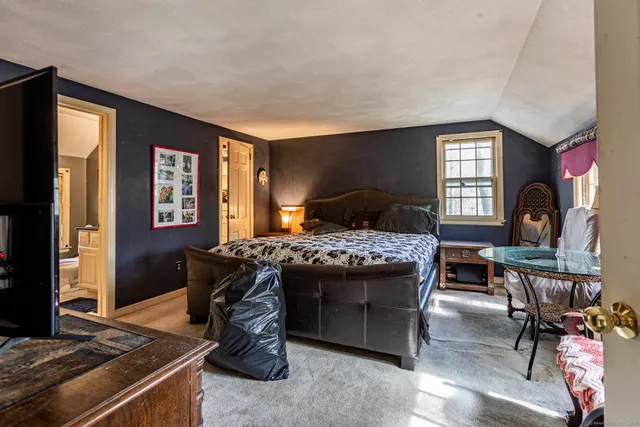 a bedroom with a bed and a table in it