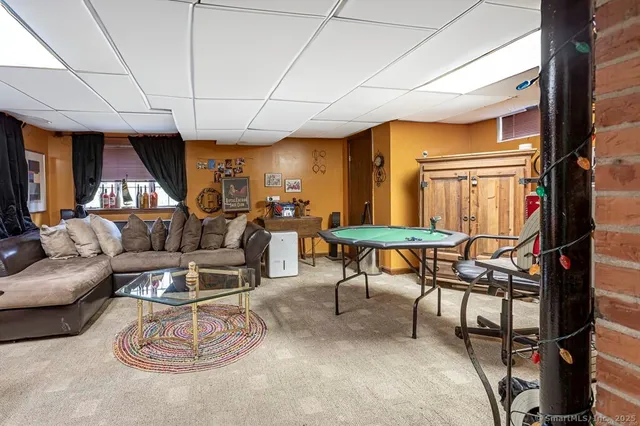 a living room with furniture a ceiling fan and a window