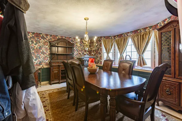 a view of a dining room with furniture window and outside view