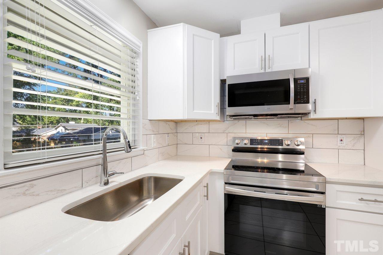 5309 Falls Of Neuse Road Raleigh, NC 27609 - Photo 11 of 38 a kitchen with stainless steel appliances a stove sink and microwave