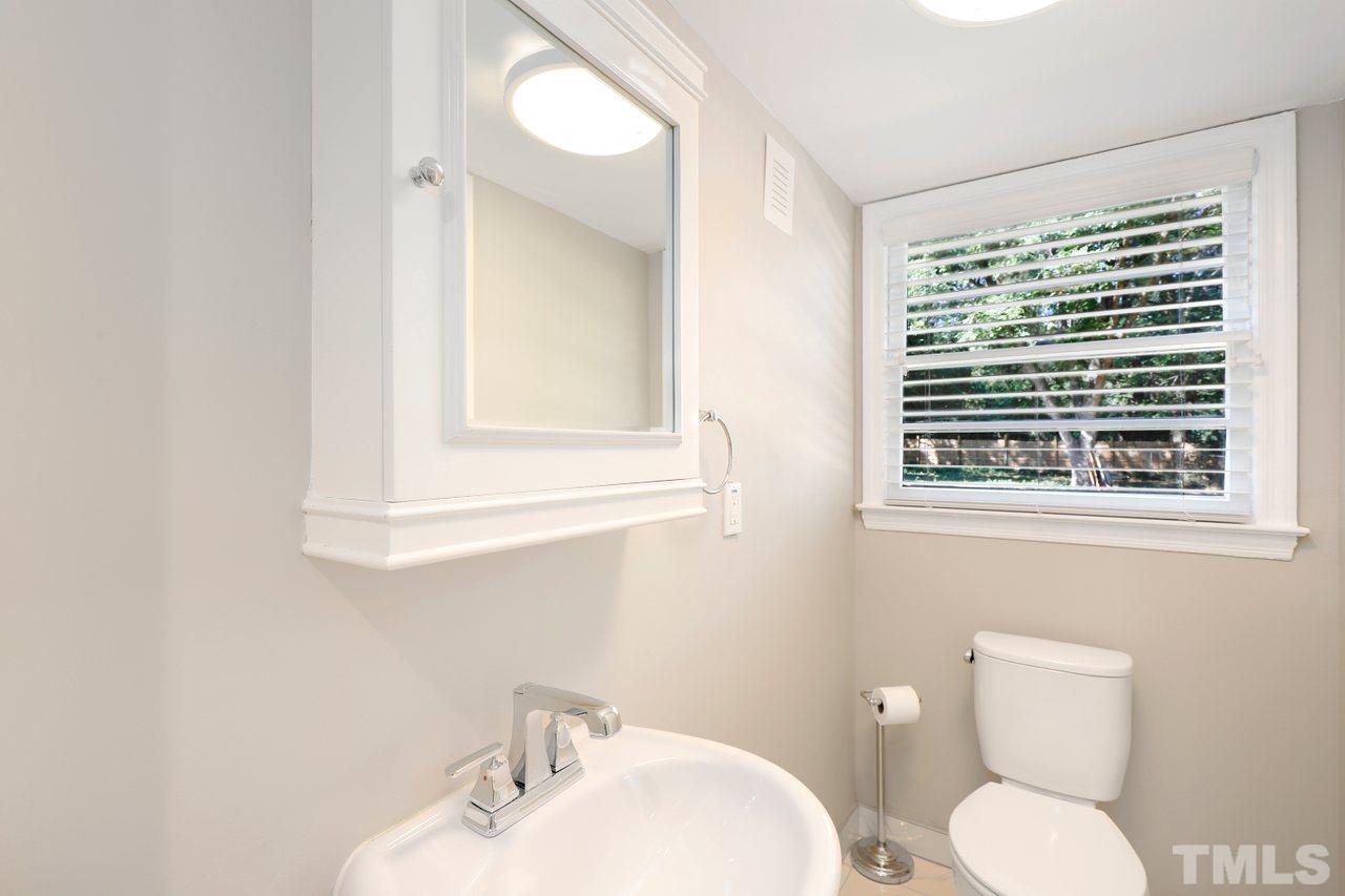 5309 Falls Of Neuse Road Raleigh, NC 27609 - Photo 12 of 38 a bathroom with a toilet a sink and a mirror