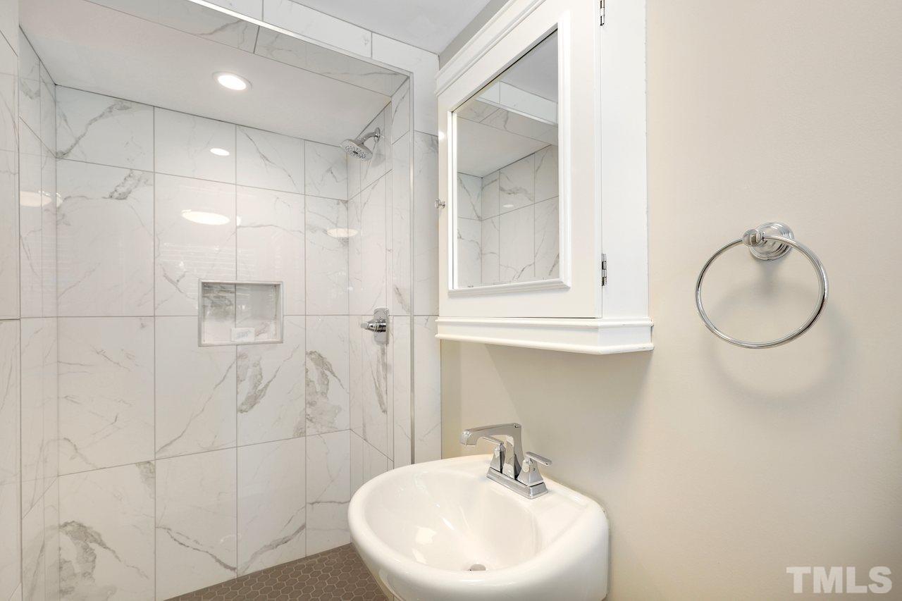 5309 Falls Of Neuse Road Raleigh, NC 27609 - Photo 13 of 38 a bathroom with a sink a toilet and shower