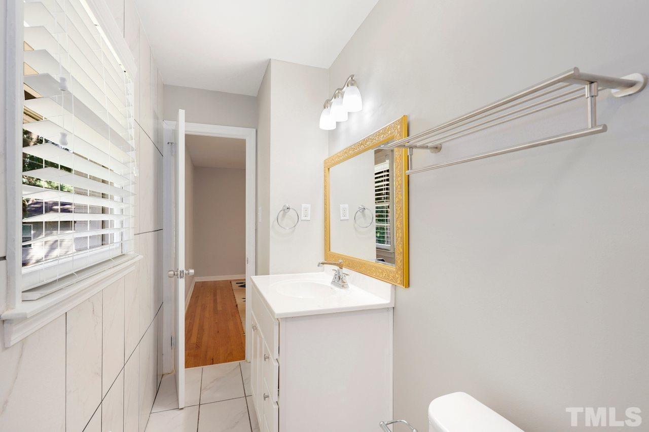 5309 Falls Of Neuse Road Raleigh, NC 27609 - Photo 17 of 38 a bathroom with a sink a toilet and shower