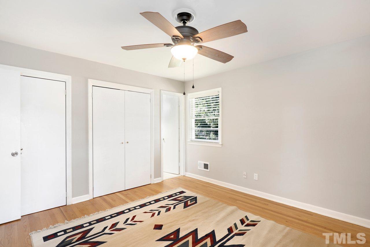 5309 Falls Of Neuse Road Raleigh, NC 27609 - Photo 22 of 38 a bedroom with a bed and a chandelier fan