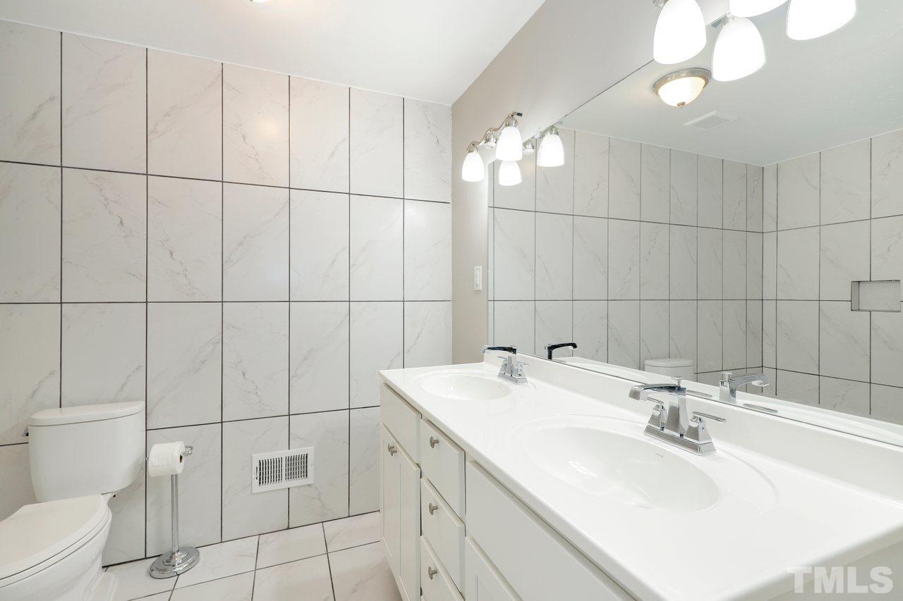 5309 Falls Of Neuse Road Raleigh, NC 27609 - Photo 23 of 38 a bathroom with a sink vanity and toilet