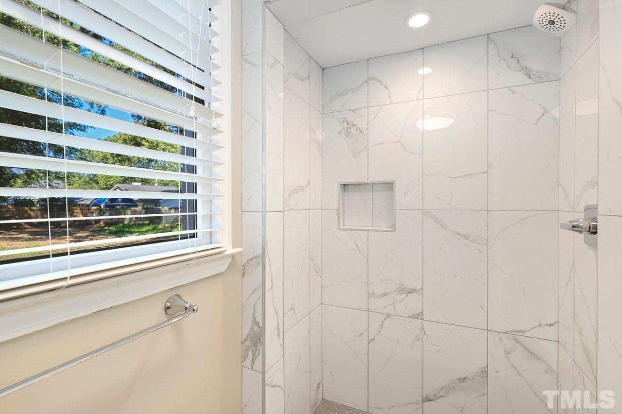 5309 Falls Of Neuse Road Raleigh, NC 27609 - Photo 31 of 38 a bathroom with a shower and a window