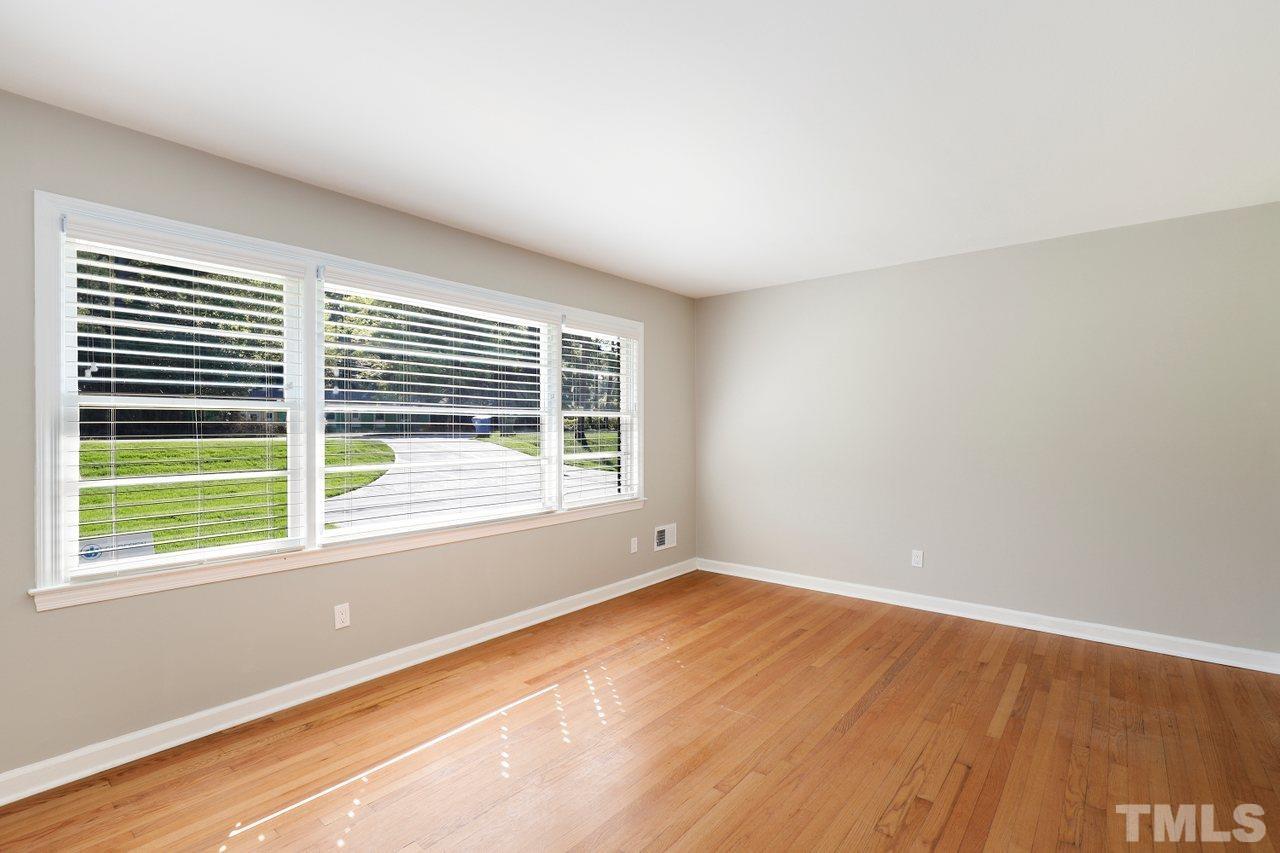 5309 Falls Of Neuse Road Raleigh, NC 27609 - Photo 5 of 38 a view of an empty room with wooden floor and a window