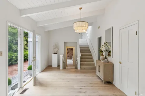 a view of a hallway view with wooden floor and staircase
