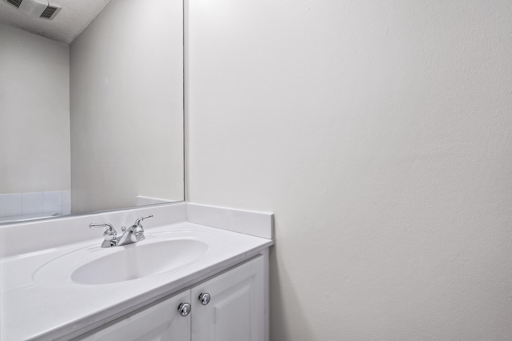 3184 West Community Drive Jupiter, FL 33458 - Photo 15 of 25 a bathroom with a sink and a mirror