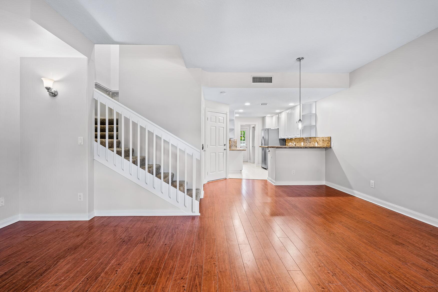 3184 West Community Drive Jupiter, FL 33458 - Photo 8 of 25 a view of empty room with wooden floor