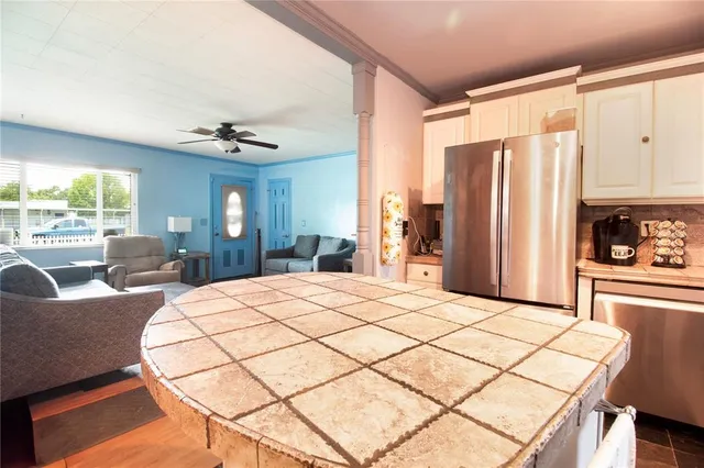 a very nice looking bedroom with a large window and a chandelier