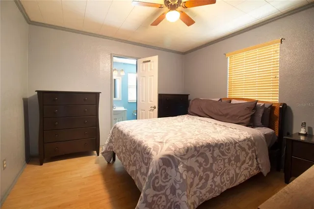 a bedroom with a bed and cabinet