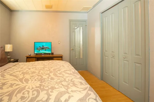 a bedroom with a bed and a flat tv screen