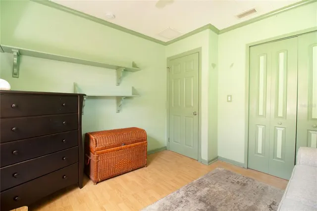 a bedroom with a bed and a dresser