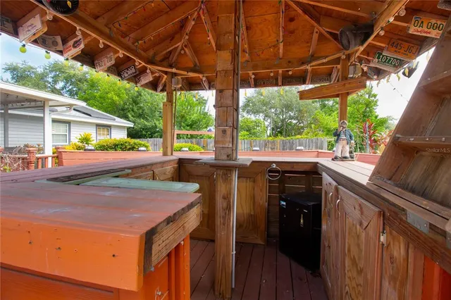 a view of a backyard with table and chairs under an umbrella