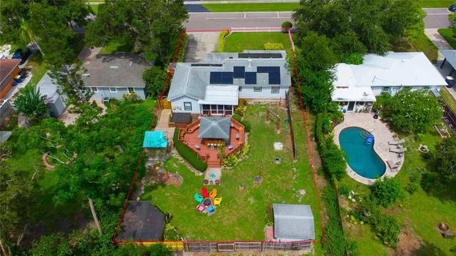 an aerial view of residential house with outdoor space and swimming pool