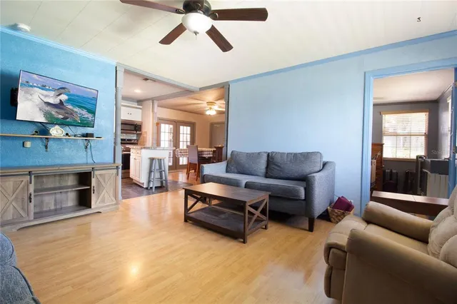 a living room with furniture and a kitchen