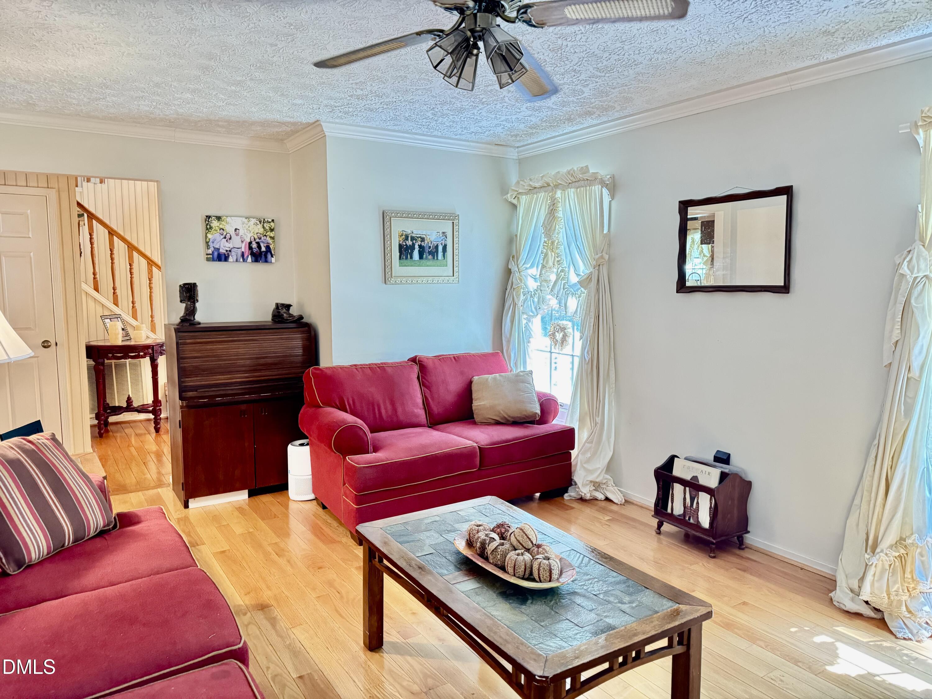 84 Wintergreen Road Henderson, NC 27537 - Photo 8 of 49 a living room with furniture and a wooden floor