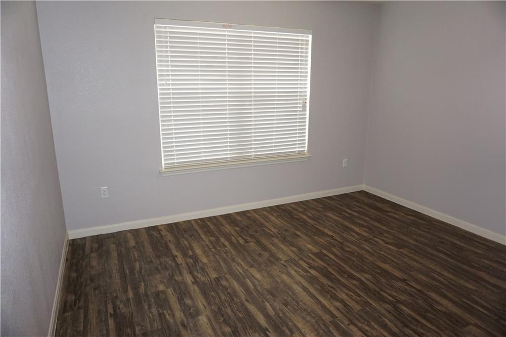 351 Musgrav Kyle, TX 78640 - Photo 13 of 21 a view of an empty room with wooden floor and a window