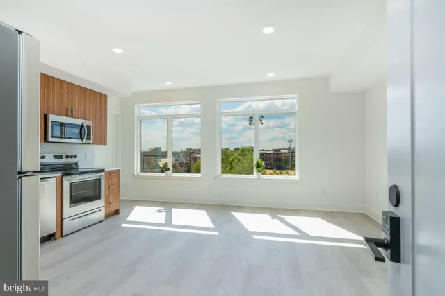 a kitchen with stainless steel appliances granite countertop a refrigerator sink and cabinets