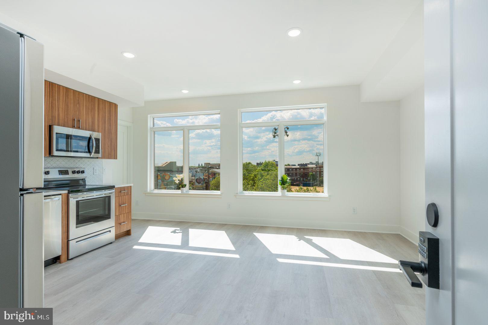 833 Wharton Street, Unit 2B405 Philadelphia, PA 19147 - Photo 14 of 15 a view of an empty room with a window and wooden floor
