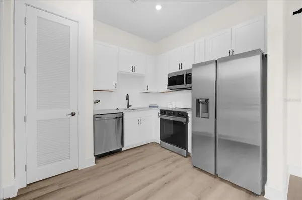 a kitchen with a refrigerator sink and stainless steel appliances