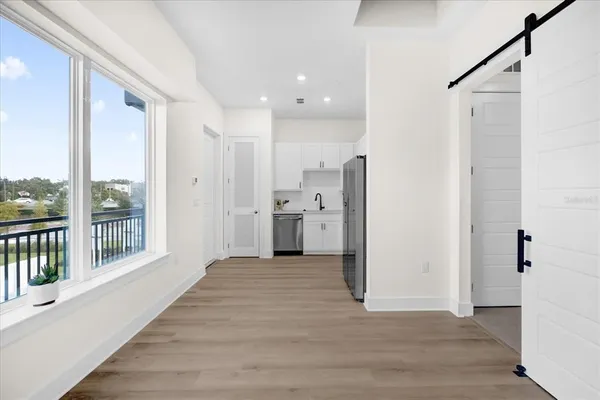 a view of a kitchen with a sink and refrigerator