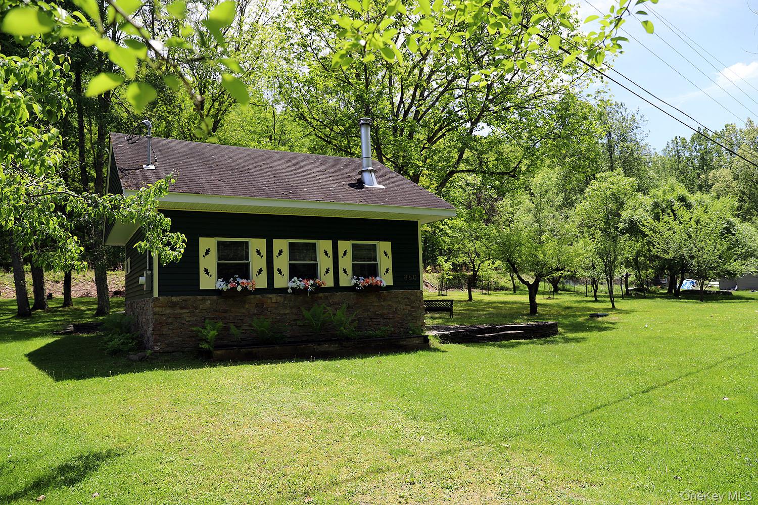 860 River Road Callicoon, NY 12723 - Photo 32 of 45 a front view of a house with a garden