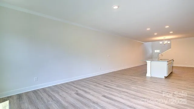 a room with wooden floor and white walls