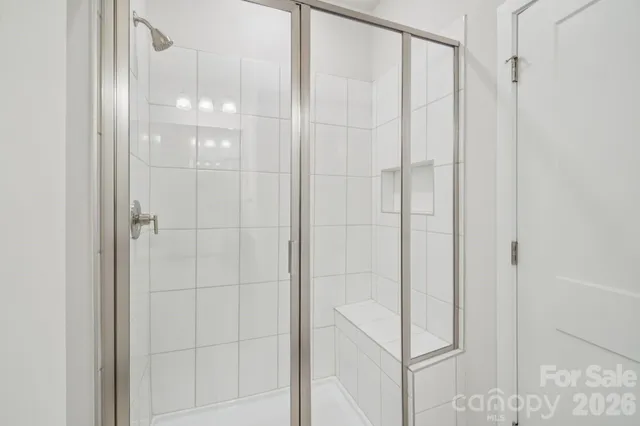 a bathroom with a glass shower door