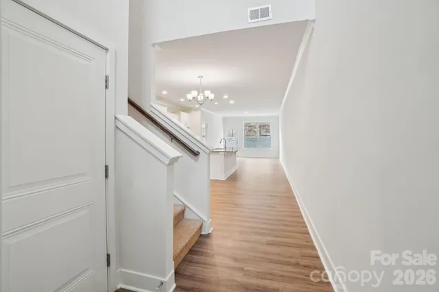 a view of entryway and hall with wooden floor