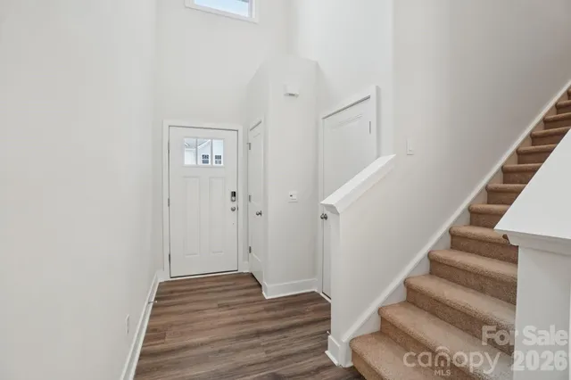 a view of a hallway with wooden floor and entryway