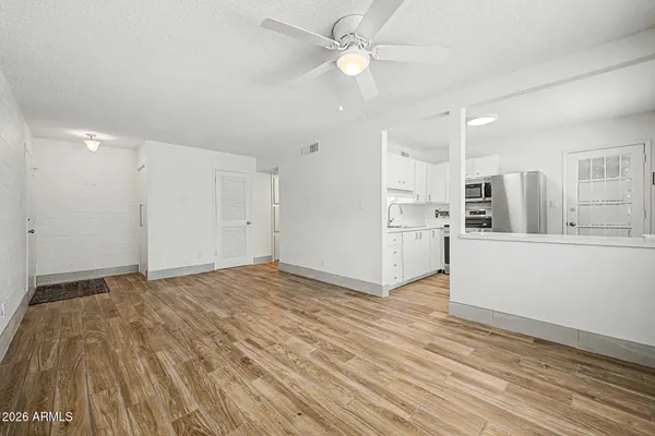 a view of an empty room with wooden floor