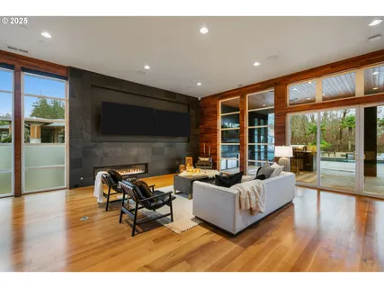 a dining room with furniture a chandelier and wooden floor