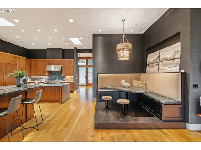 a kitchen with stainless steel appliances a stove a sink and a microwave