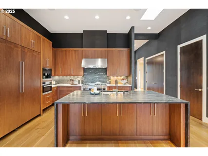 a kitchen with counter top space and living room