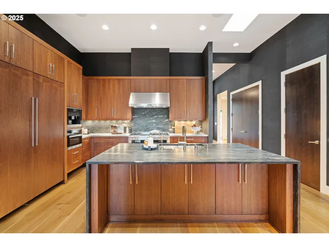 a kitchen with counter top space and living room