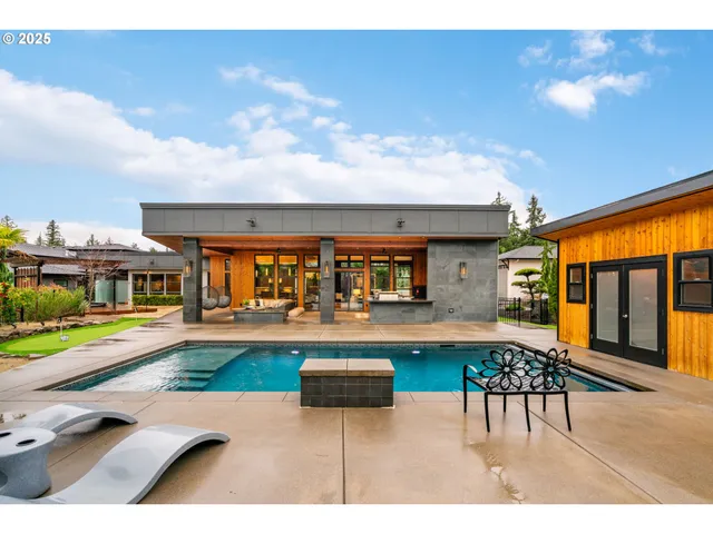 a swimming pool view with a outdoor seating
