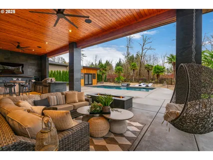 a living room with furniture a flat screen tv and a floor to ceiling window